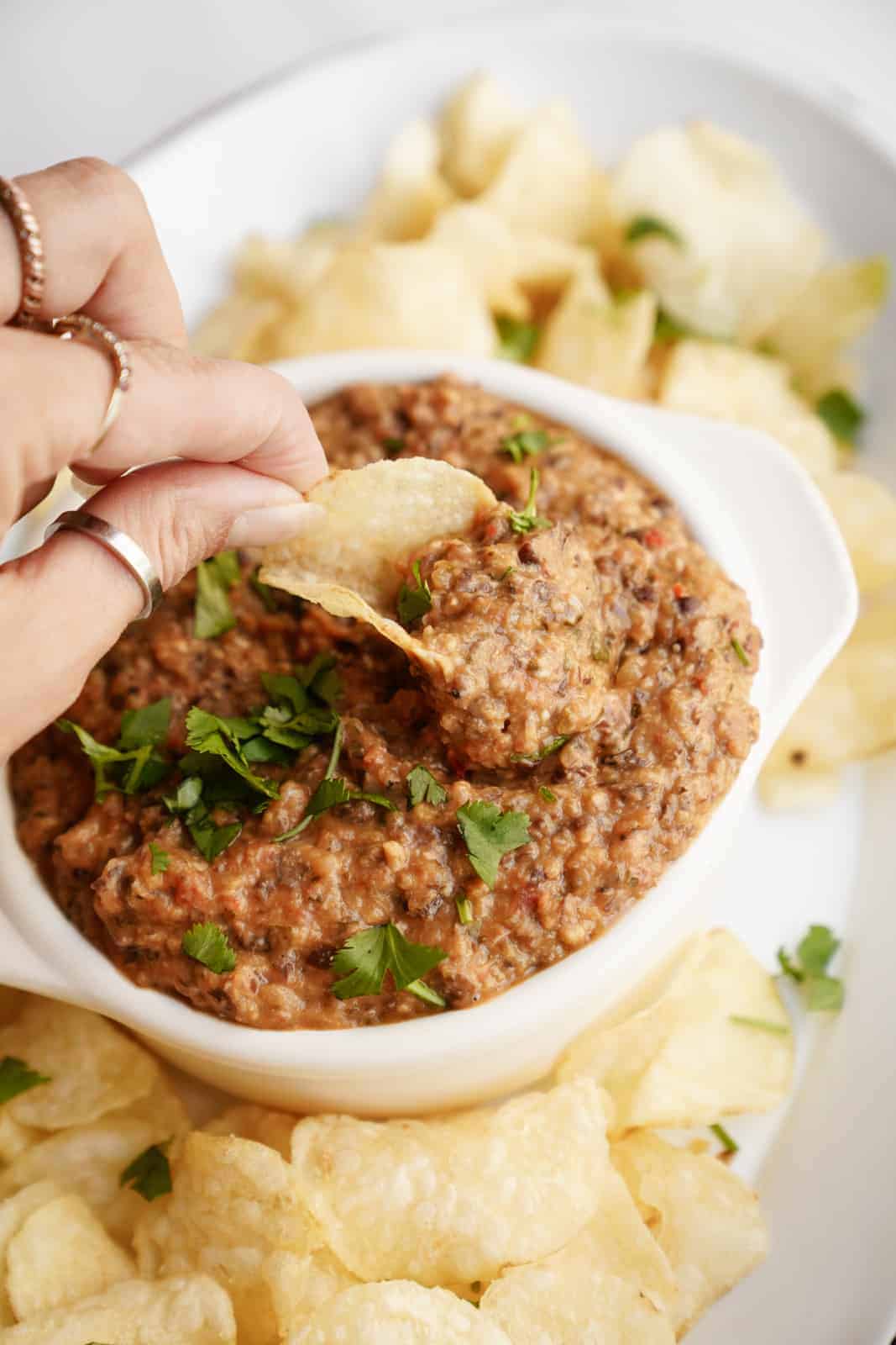 Black Bean Dip Recipe on a serving dish with potato chips.