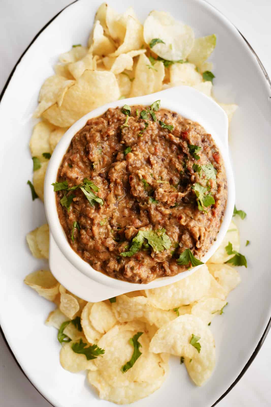 Black Bean Dip Recipe on a serving dish with potato chips.