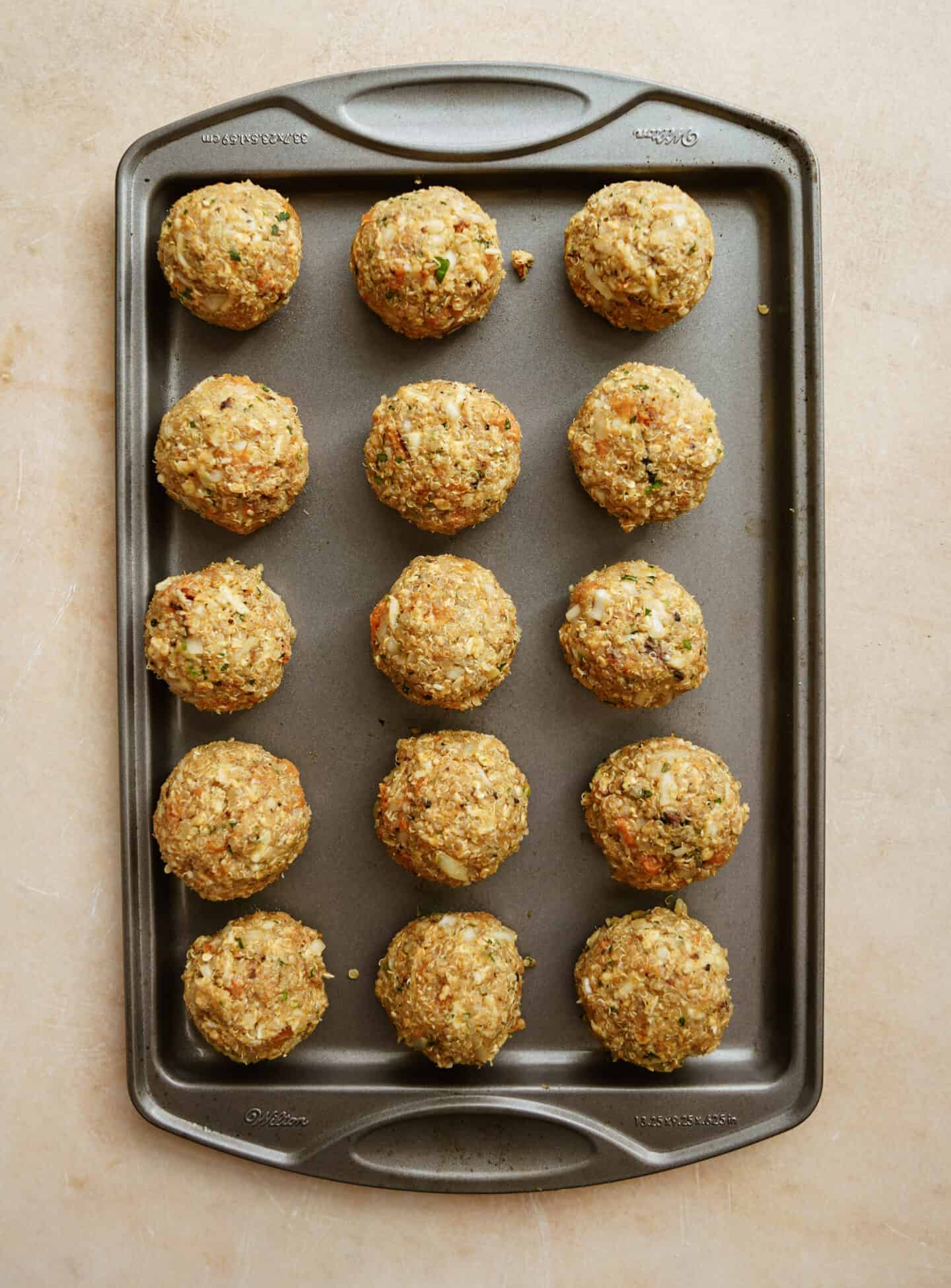 Scooped sweet potato balls on a baking sheet