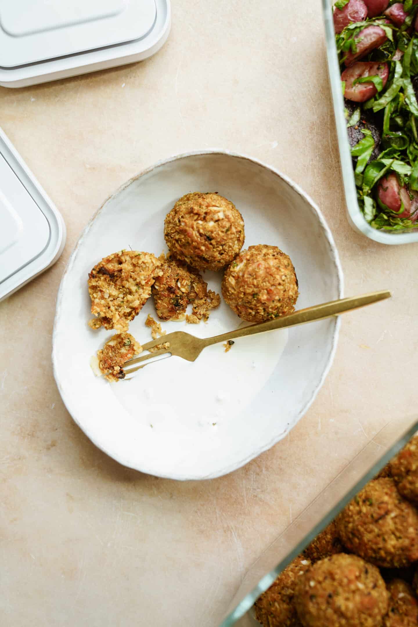 Sweet potato balls recipe on white plate with a fork cutting into one