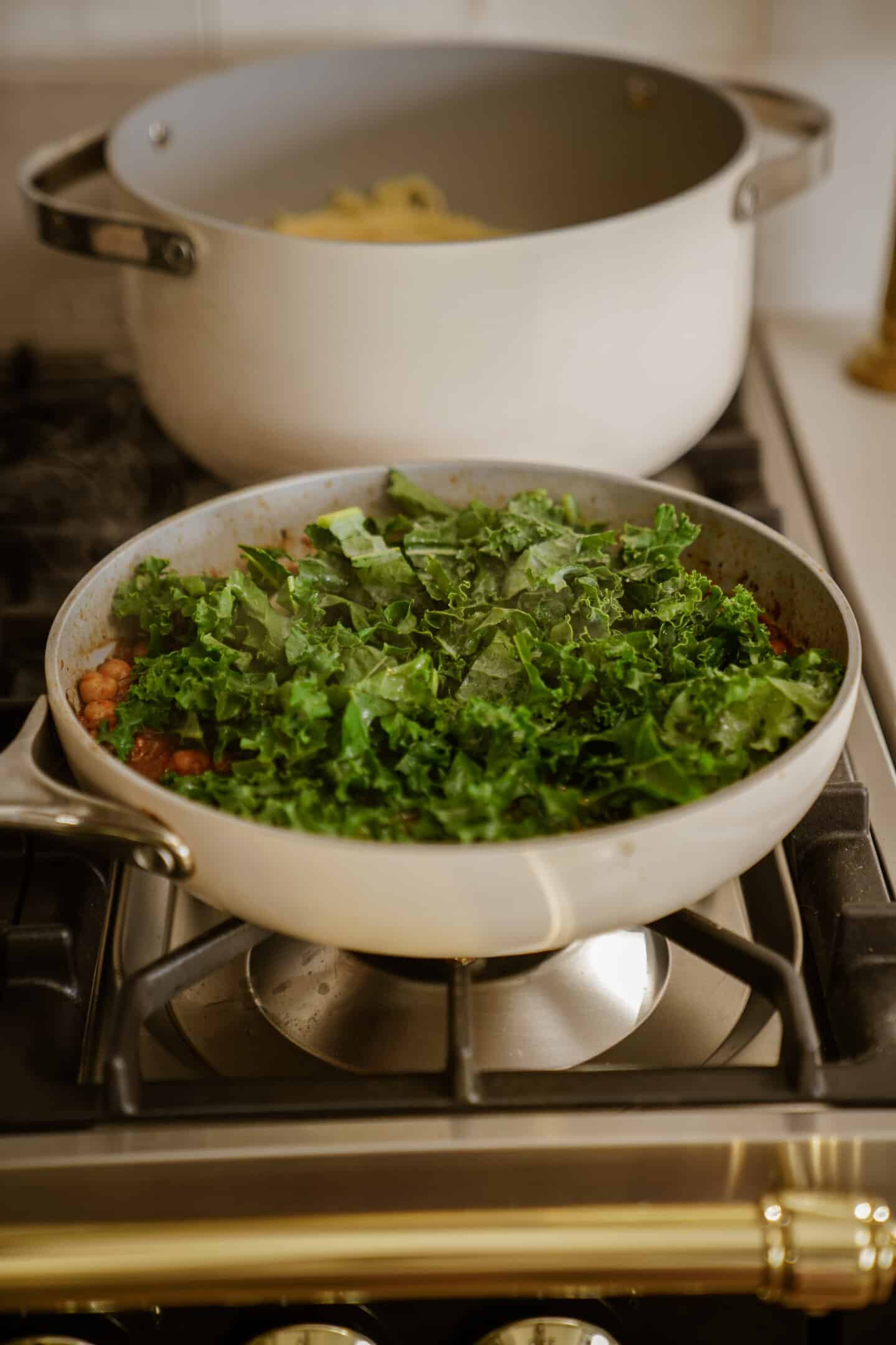 Kales added to pan for chickpea pasta