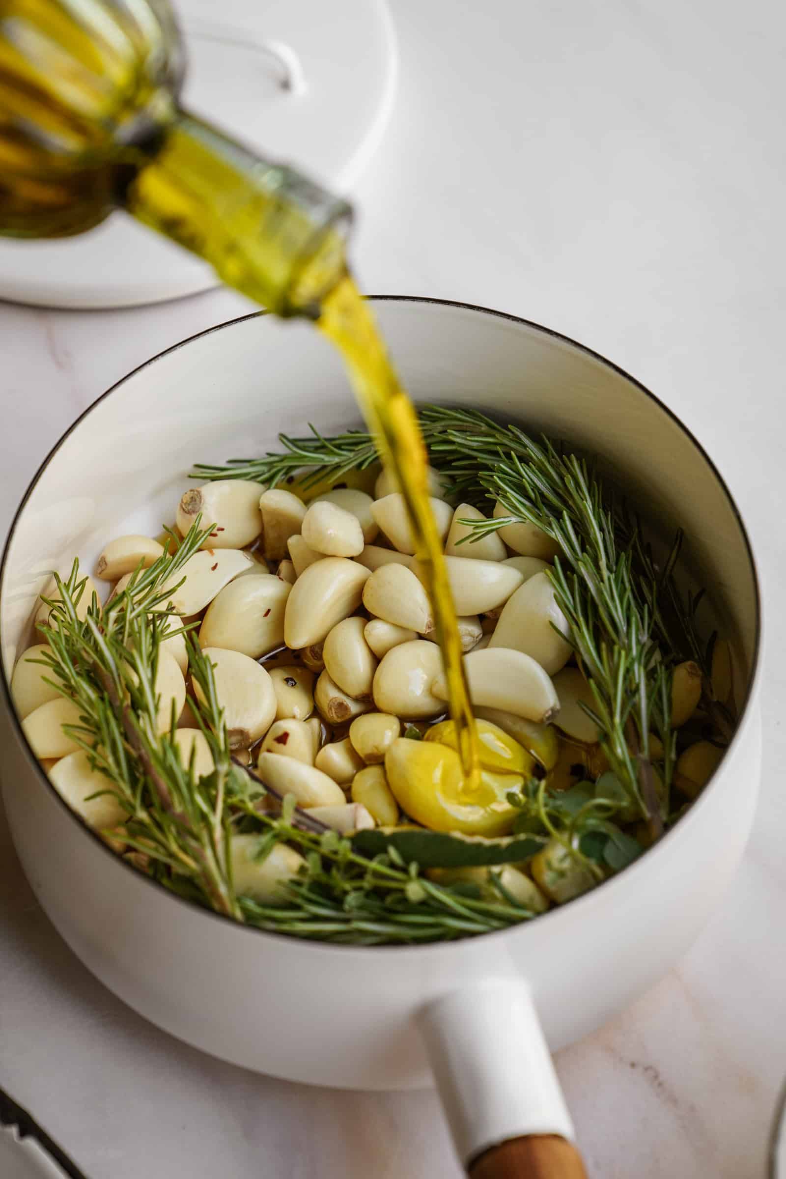 Ingredients for garlic confit in pot
