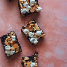 vegan s'mores brownies on pink countertop.