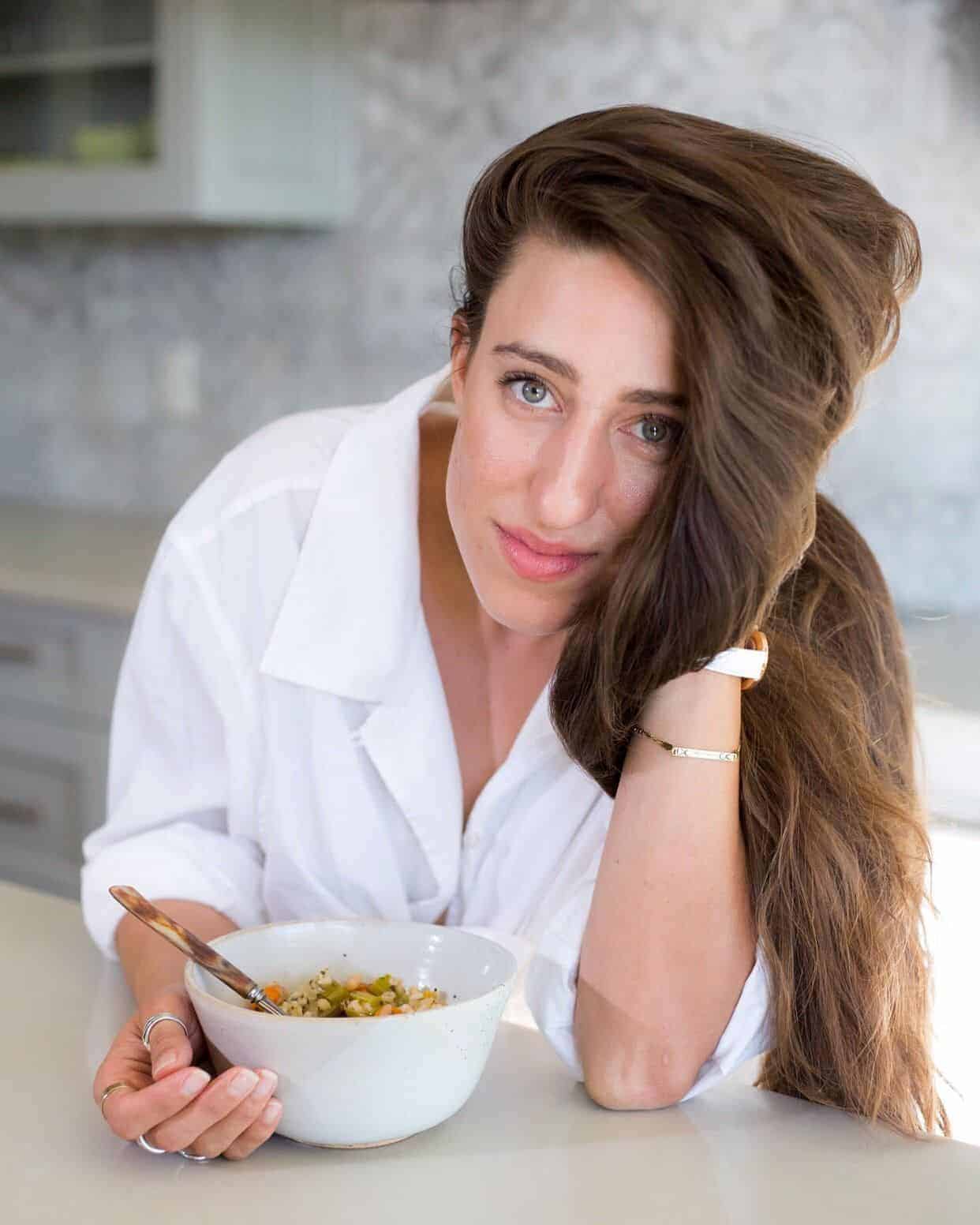 Maria, a 5 AM Club advocate, smiling over a bowl of food.