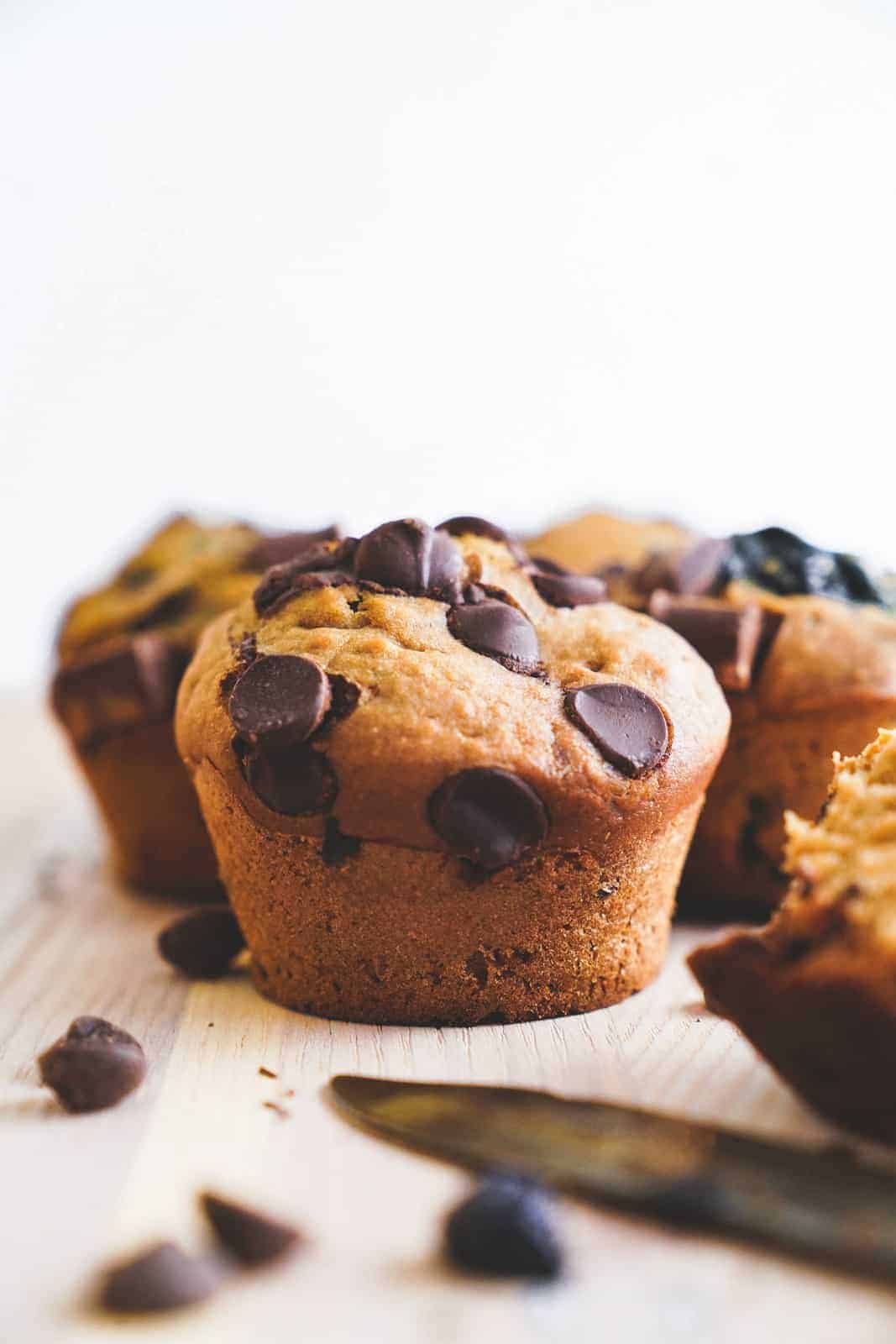 Close-up of vegan chocolate chip muffins from side angle.