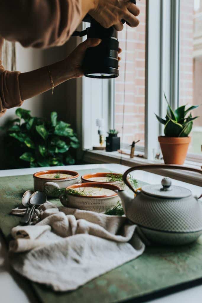 Taking a photo of plant based soup on counter