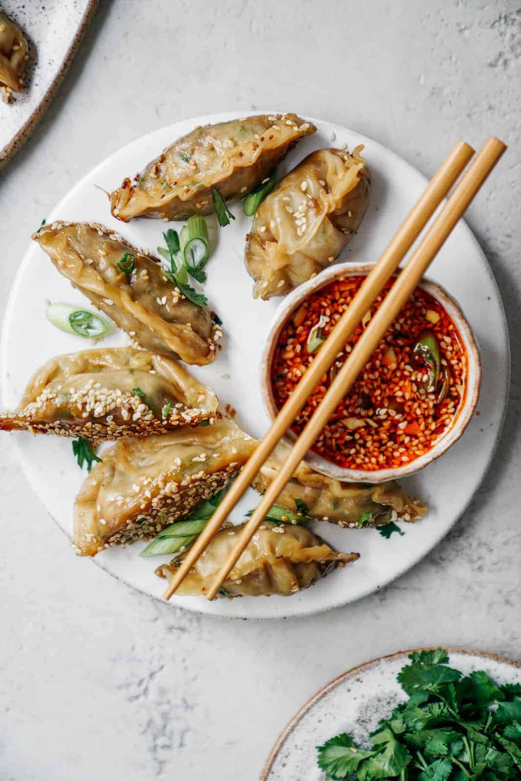 This super easy vegan potsticker recipe goes so well with my sesame chilli dipping sauce. Your whole family will love making and eating them!