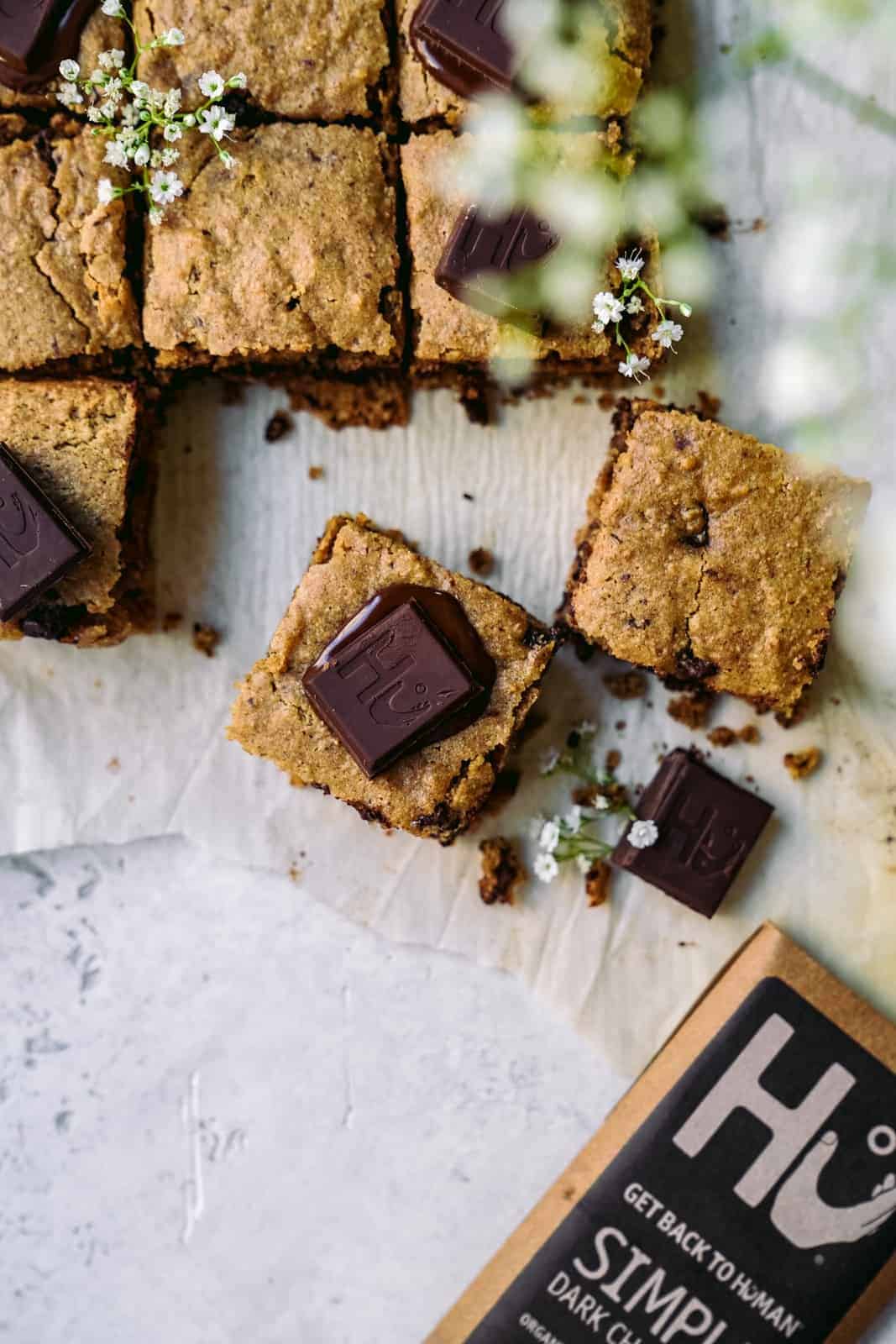 Pieces of Vegan Blondies with chocolate chunks on top