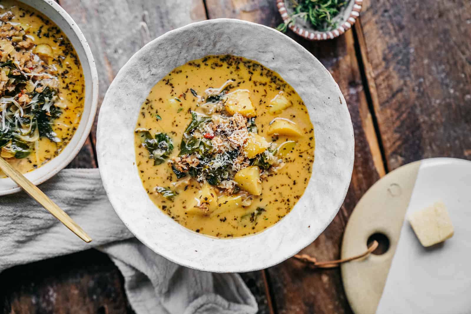 vegan zuppa toscana from overhead on a wooden table ready to be eaten.