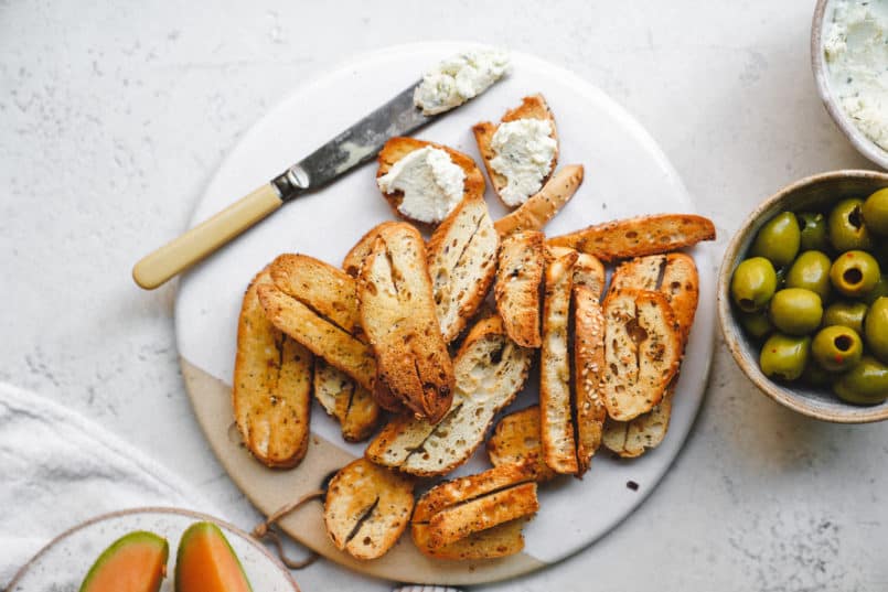 This vegan garlic herb cream cheese is so smooth and rich, it is perfect for spreading over the Silver Hills Organic Everything Bagels.