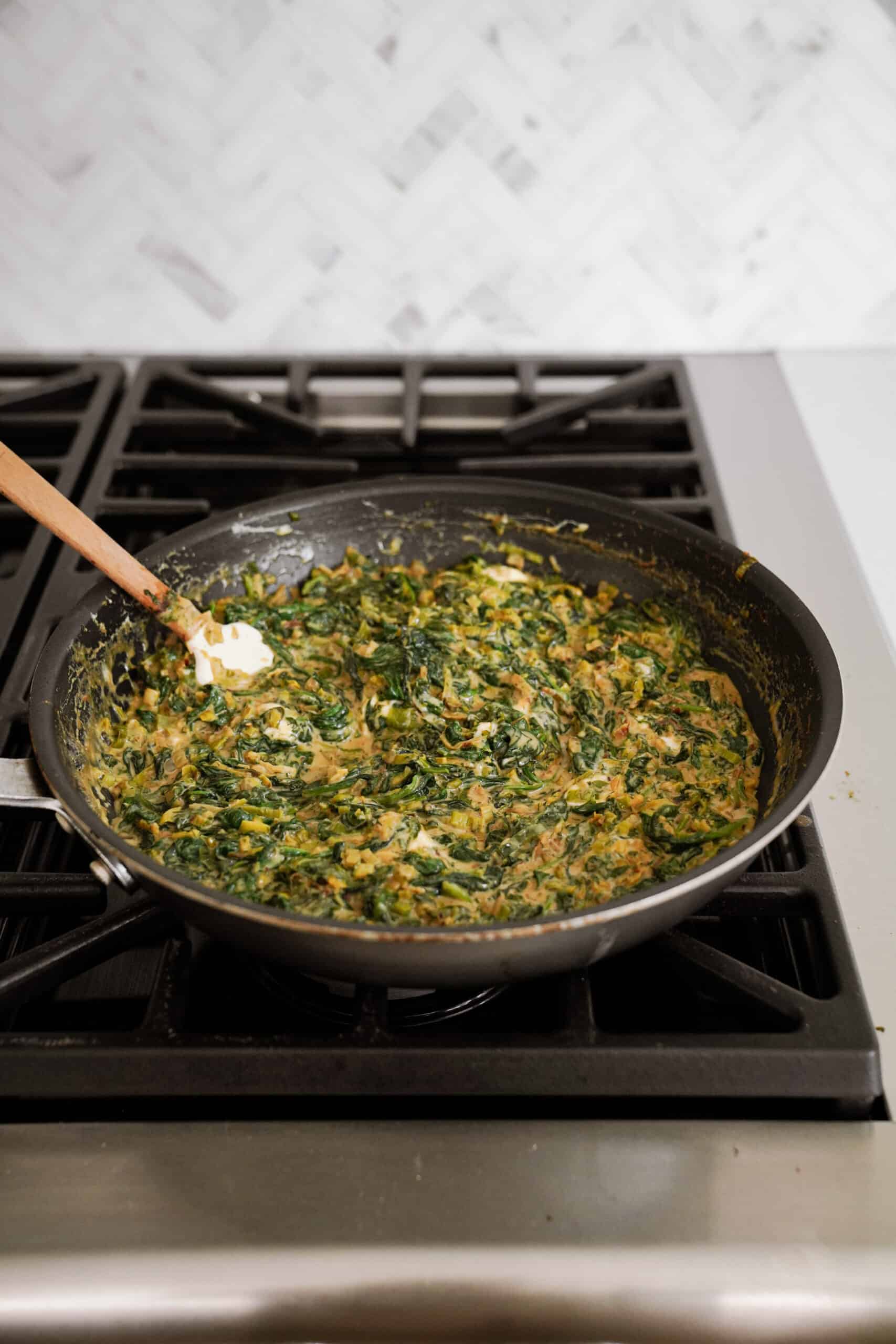 Filling for spinach pies in a frying pan