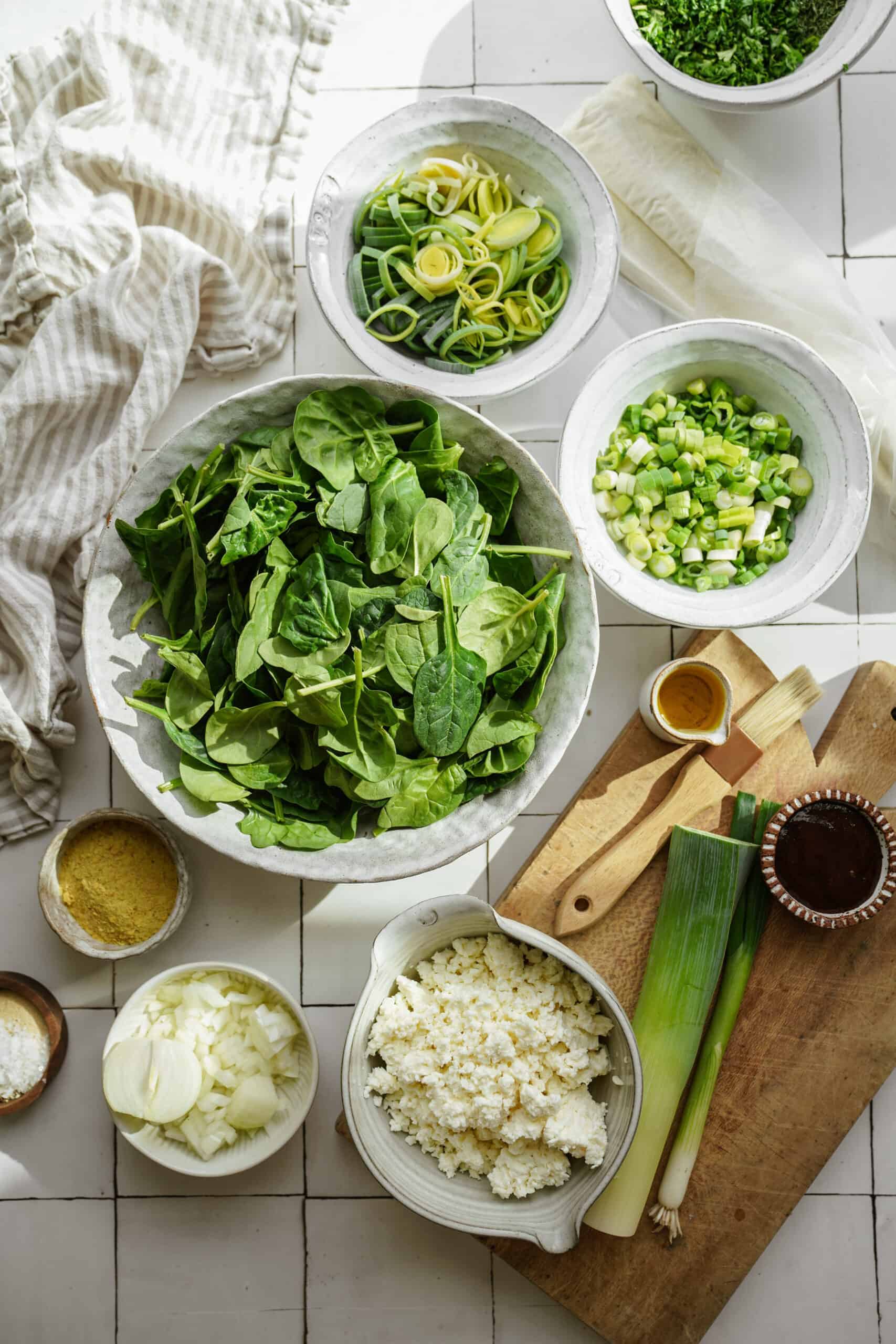 Fresh ingredients for spinach pie on a counter