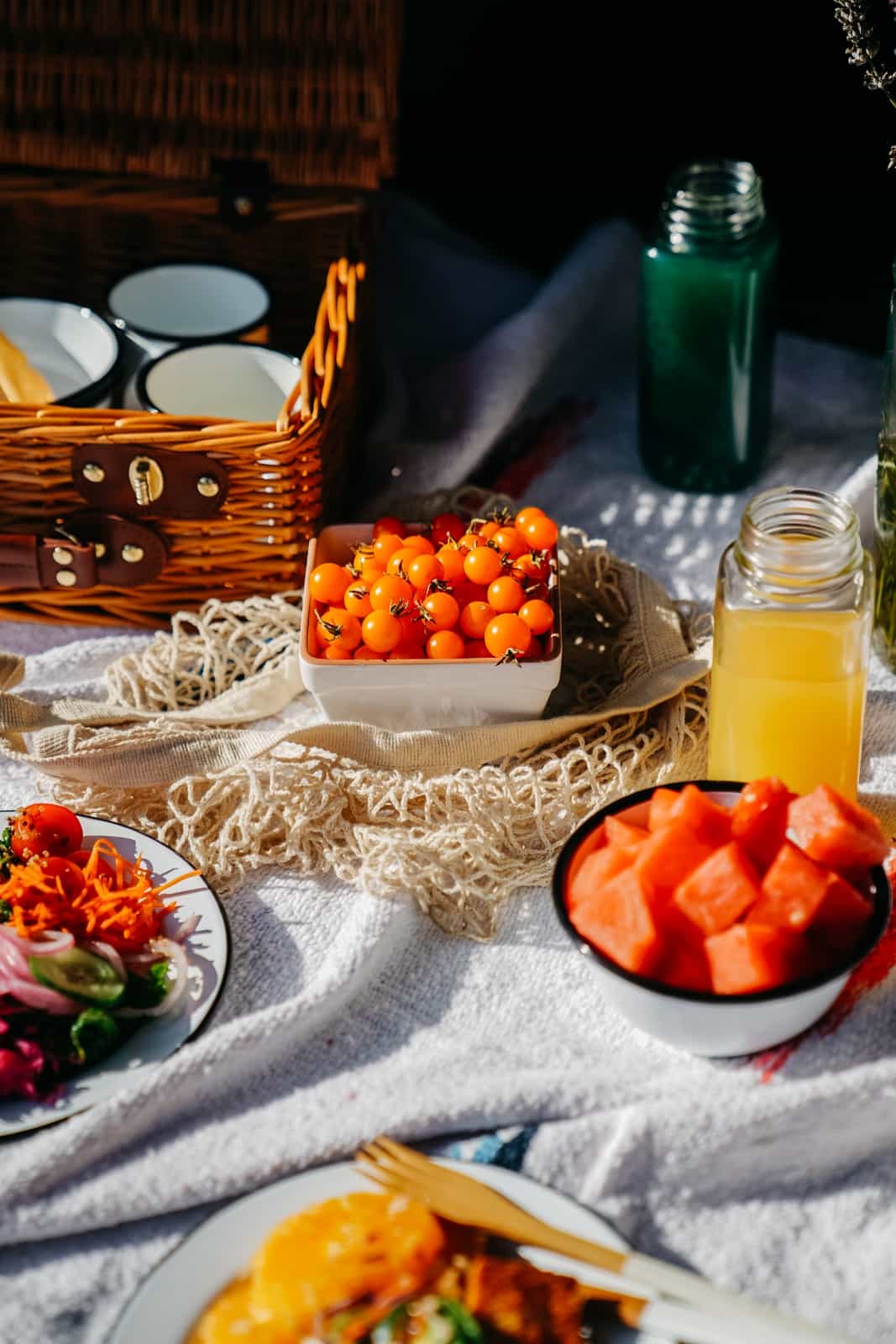 Fruit set out on a picnic blanket.