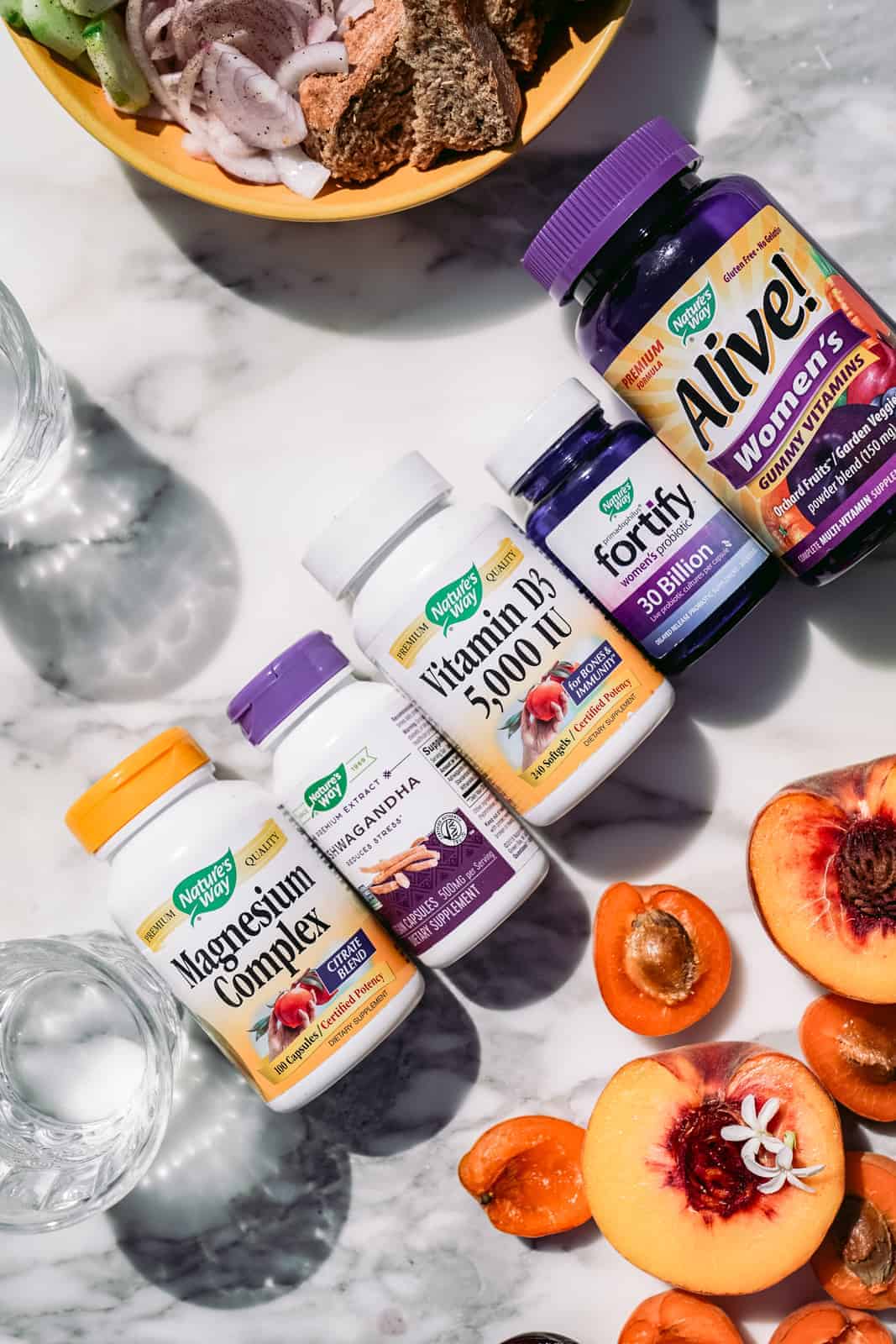 Nature's Way vitamins and supplements laying on a table.