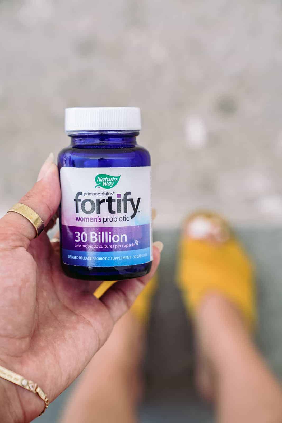 Nature's Way women's probiotics bottle held by Maria who is giving her international travel tips.
