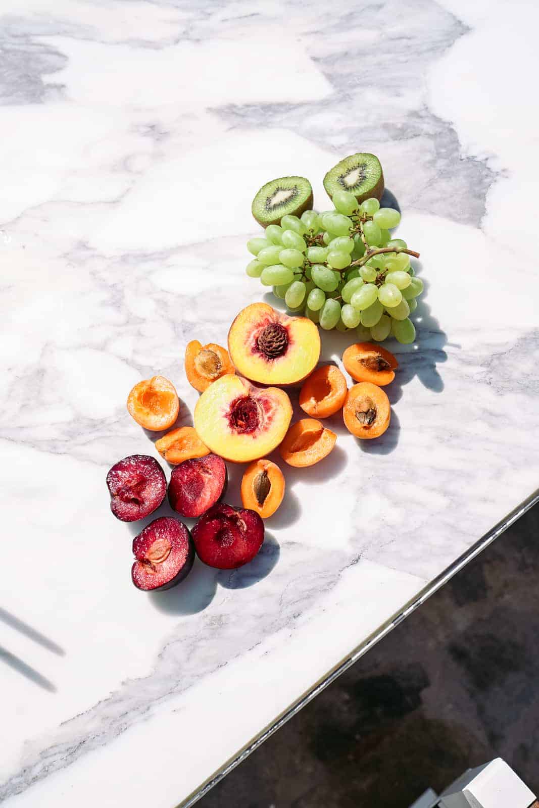 Healthy fruit on a white marble table.