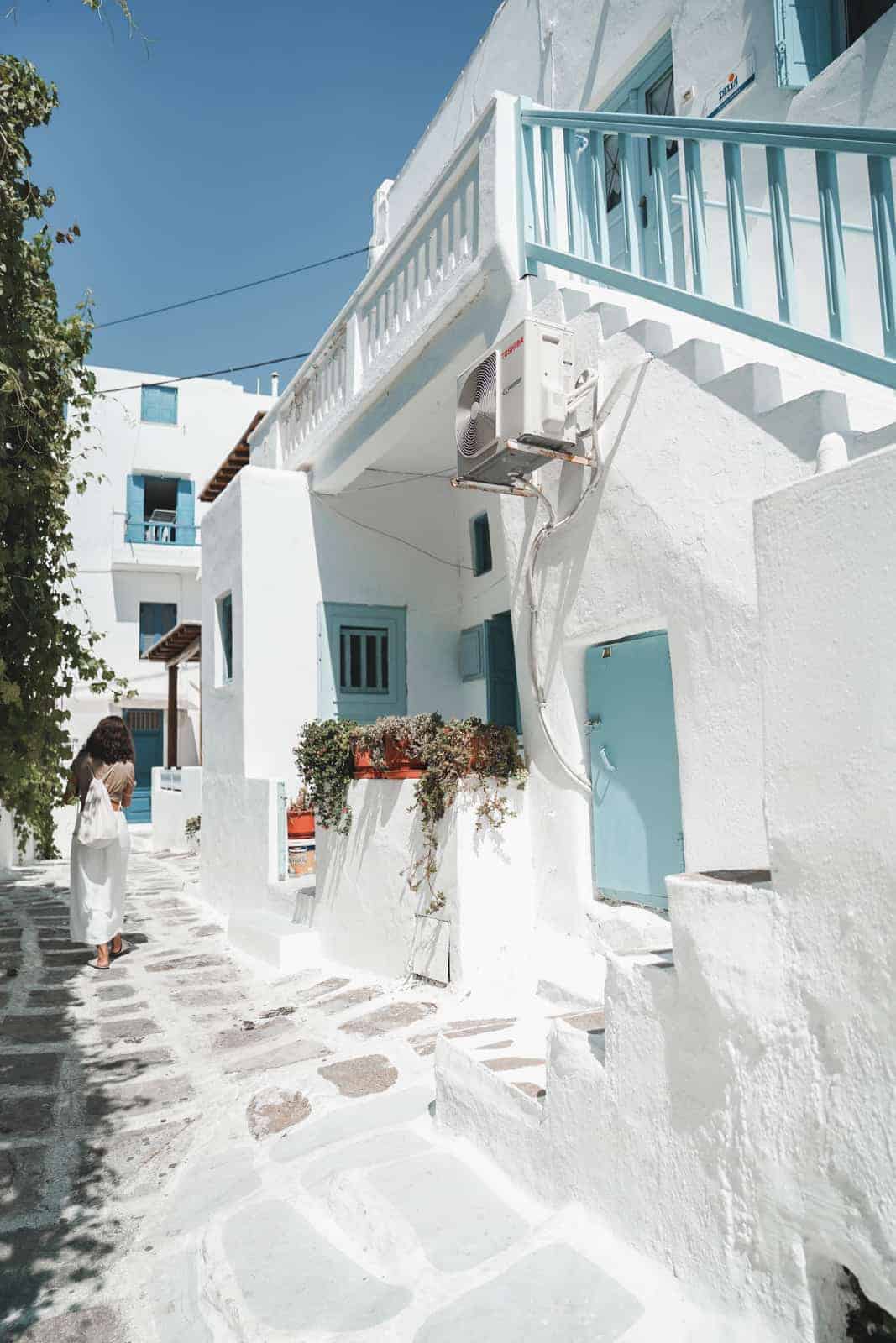 Wondering the streets of Mykonos, Greece among white buildings. 