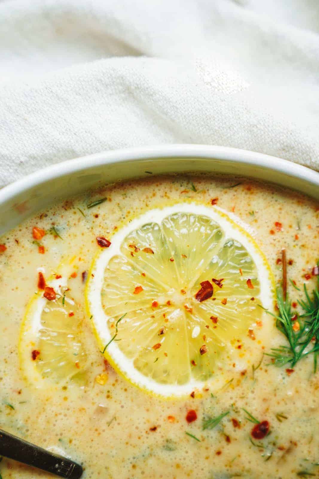 Close up of lemon in Greek Lemon Rice Soup.