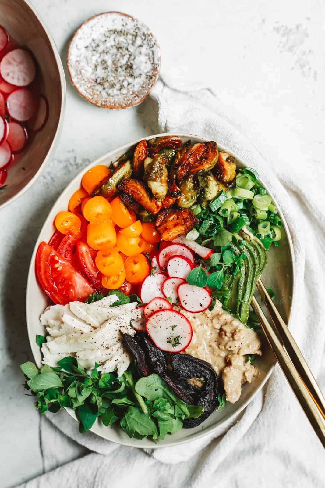 A colorful vegan cobb salad in a serving dish.