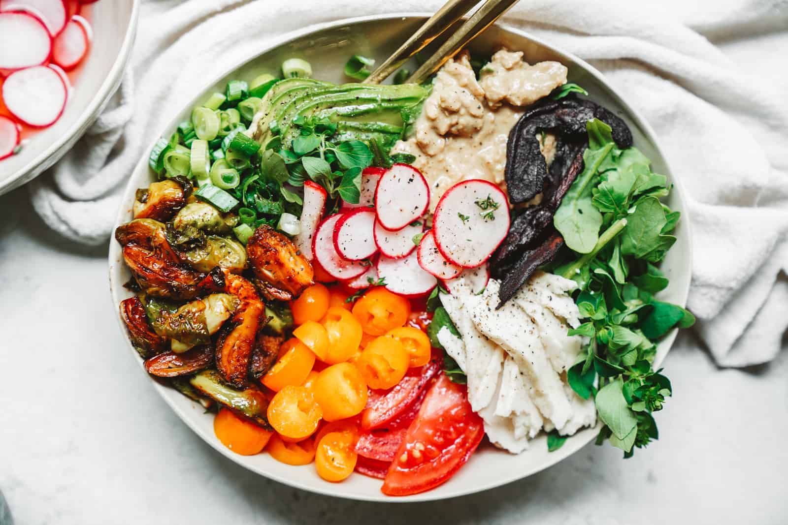 A colorful vegan cobb salad in a serving dish.