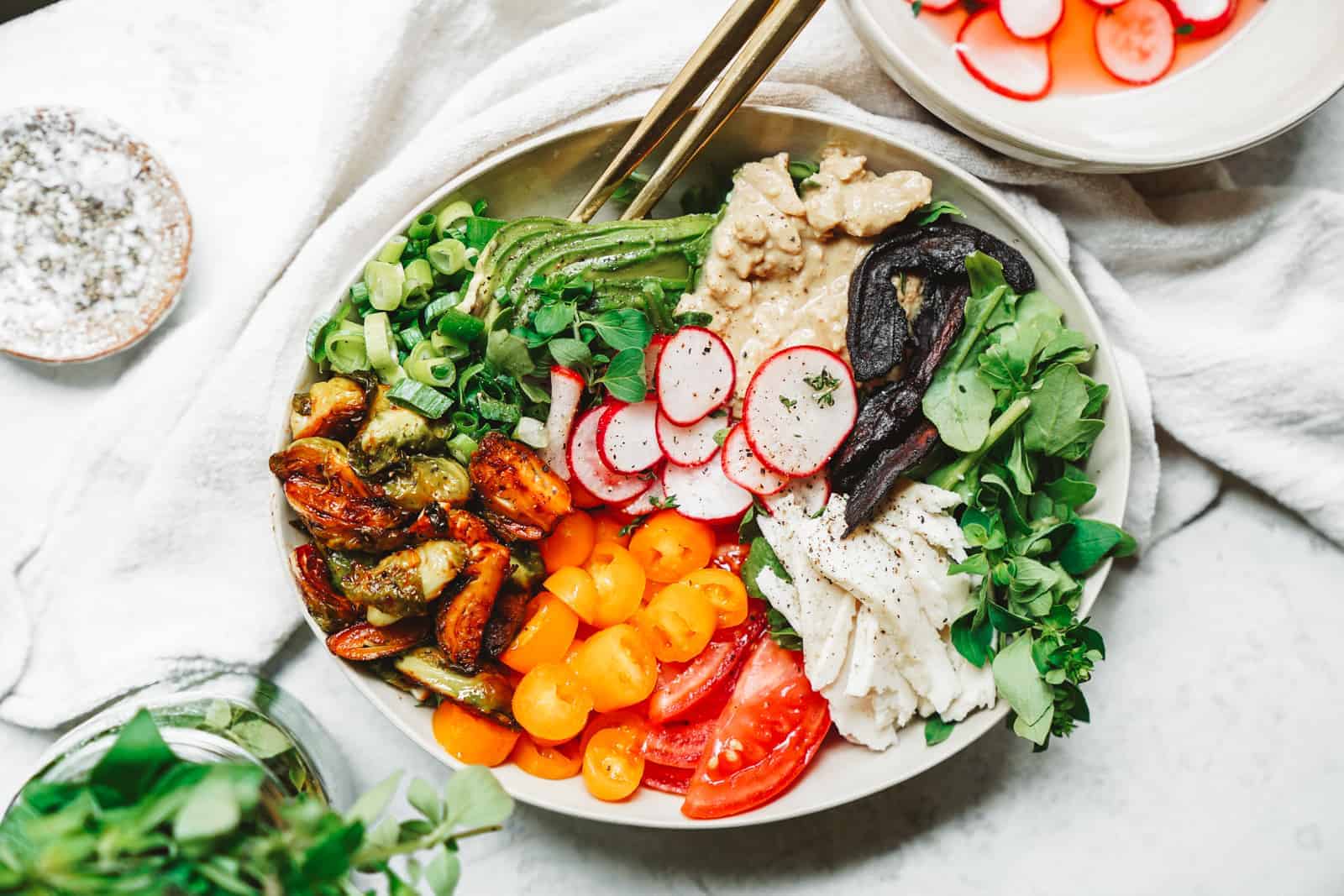 A colorful vegan cobb salad in a serving dish.