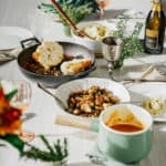 vegan brussel sprouts recipe on table with other thanksgiving foods