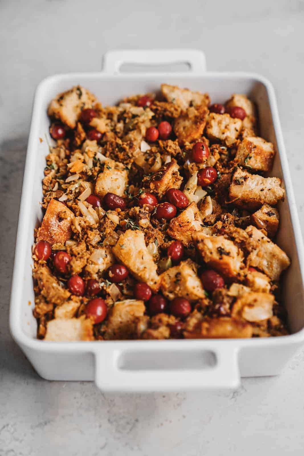 Baking dish of vegan stuffing with cranberries.