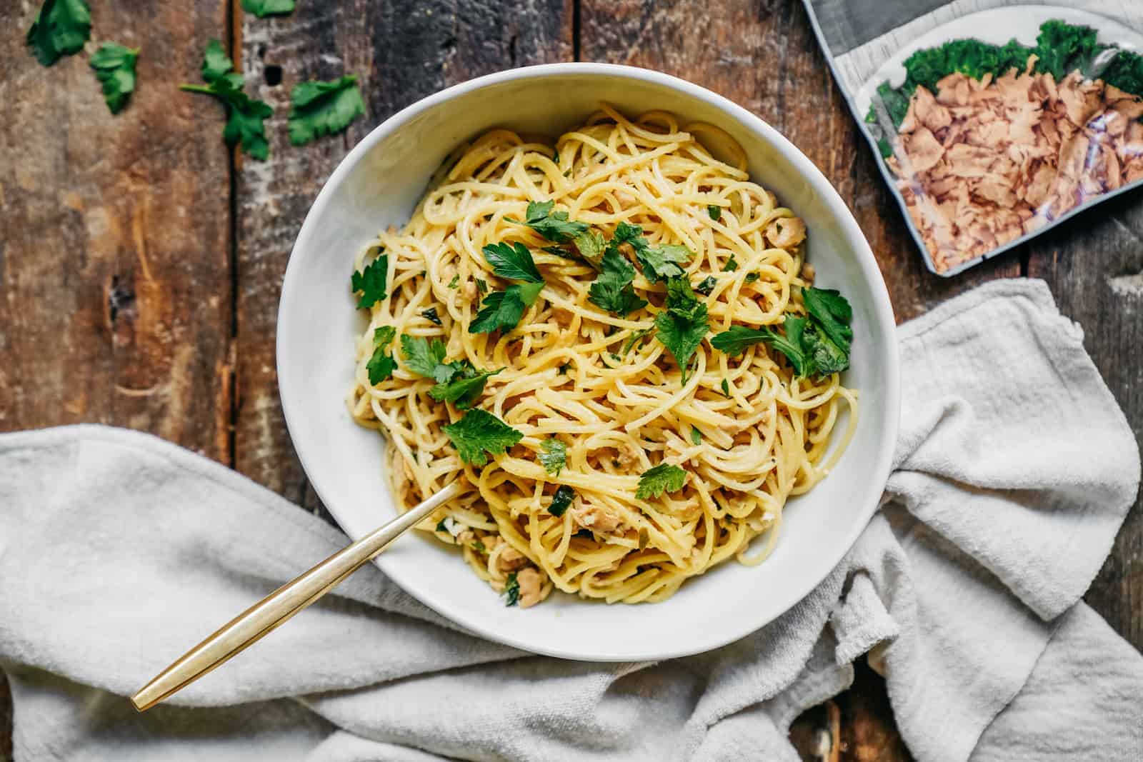 Bowl of Tuna Lemon Vegan Pasta Recipe on wood countertop.