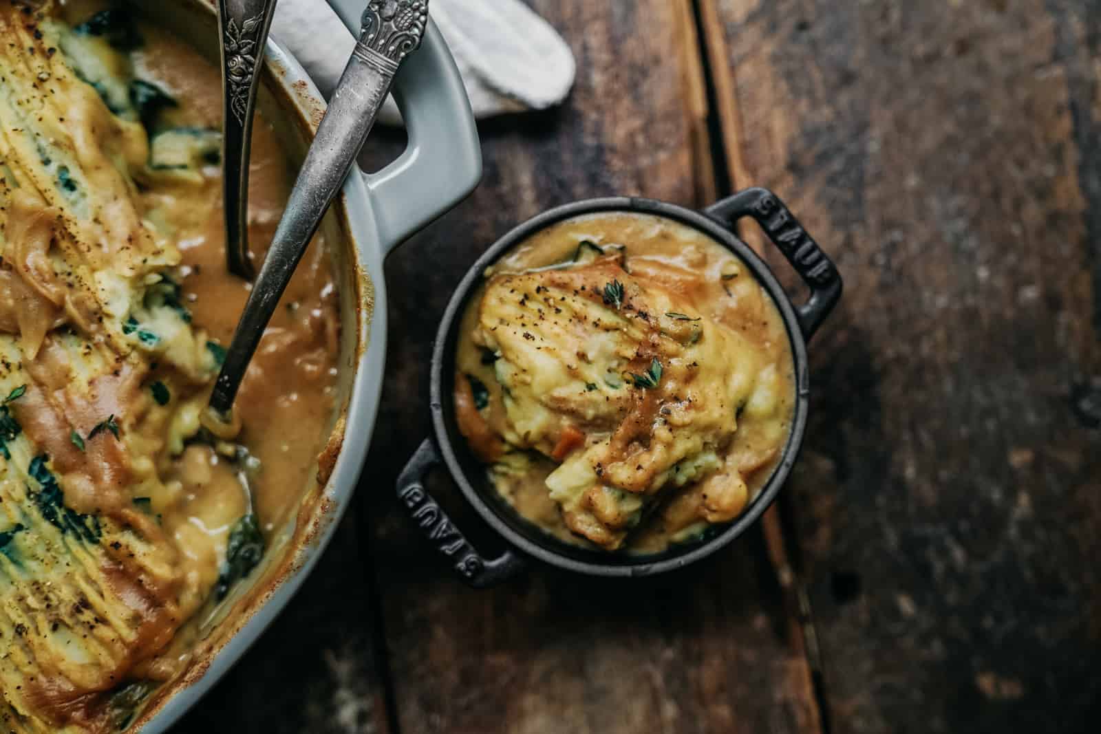 Yummy vegan mashed potatoes with gravy served in a Staub Cocotte