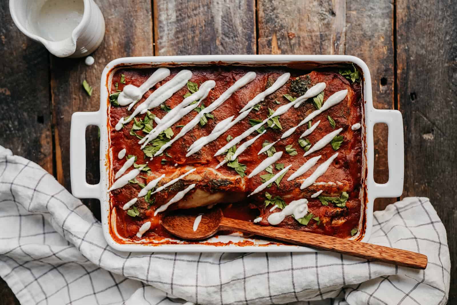 Overhead shot of casserole dish on wooden counter with Vegan Cabbage Rolls inside.