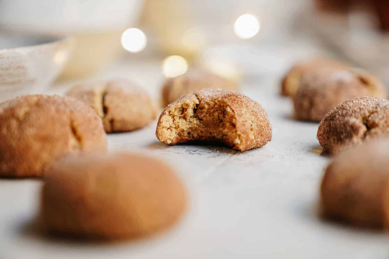 Close-up of vegan sugar cookie recipe with a bite taken out of the cookie.