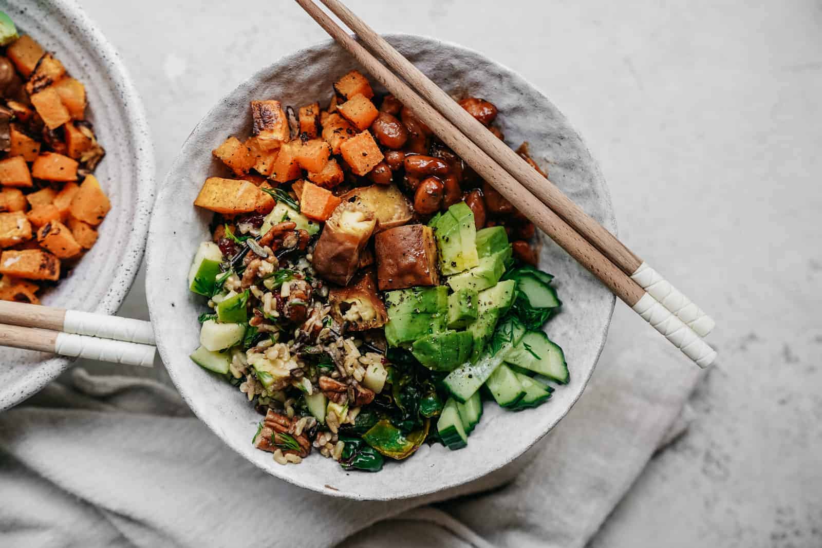 Buddha Bowl sitting on a counter top with yummy sweet potatoes and veggies.