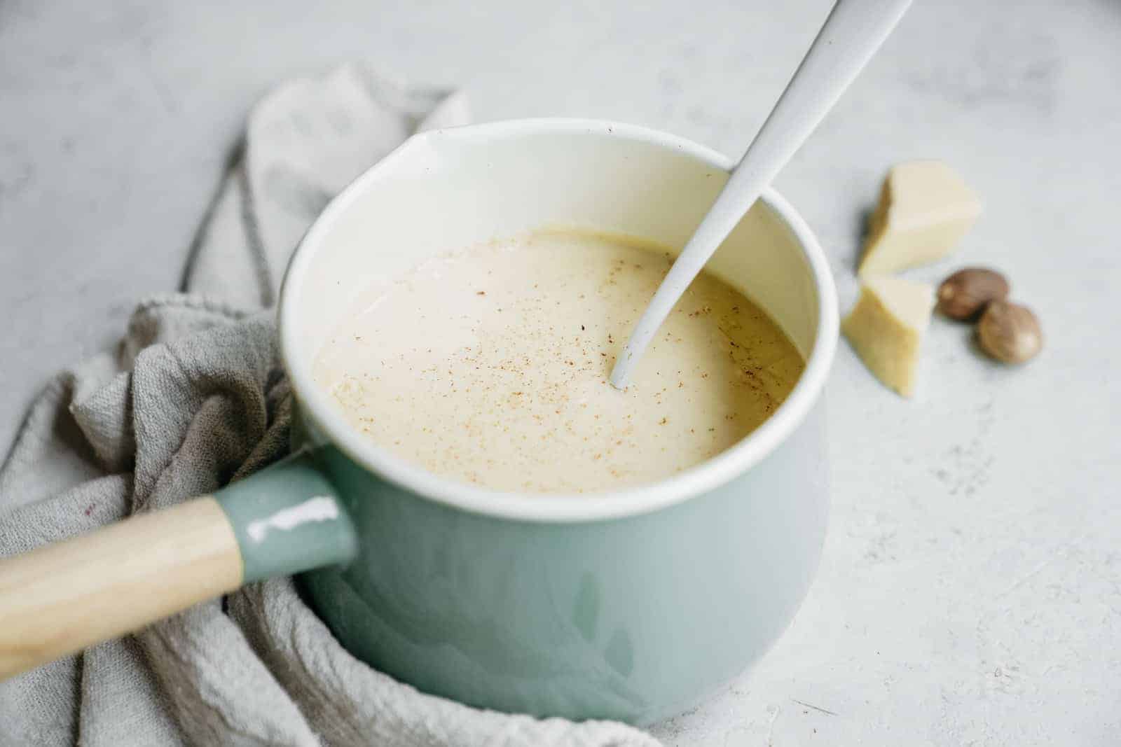 How do you make bechamel sauce vegan? This photo illustrates just how much it looks like the real thing. In a pot, on a counter.