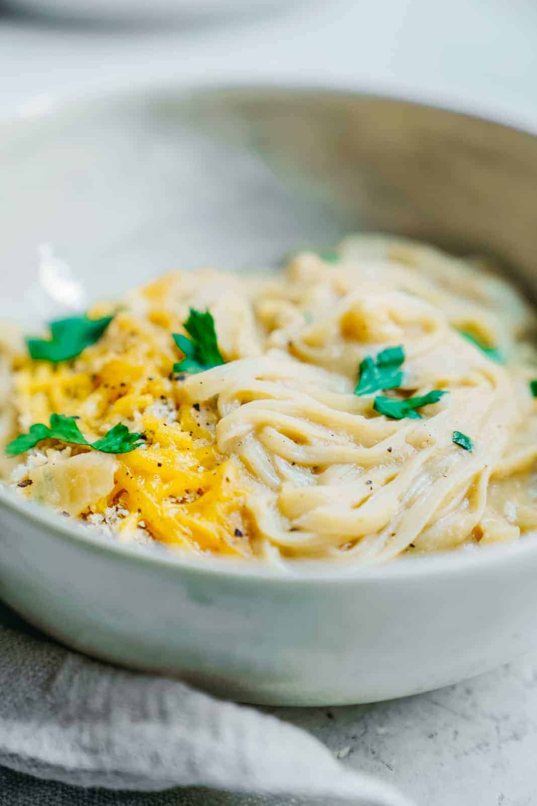 Cauliflower Cheese Sauce over a bowl of fettuccini noodles
