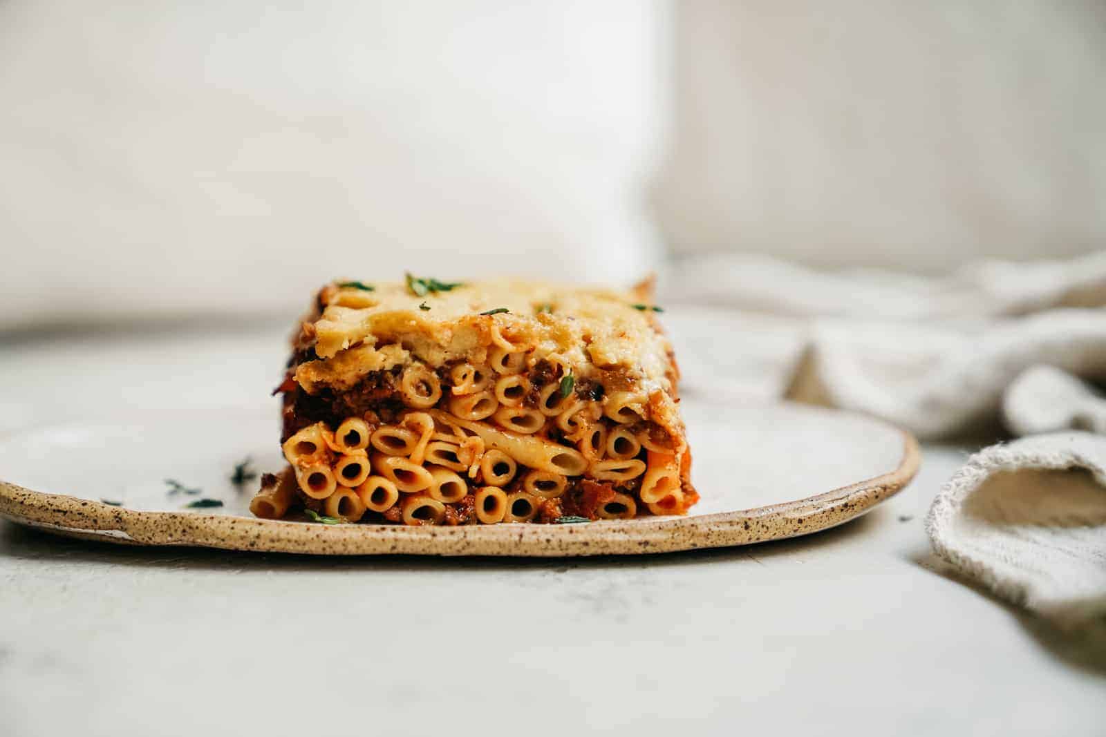 Side of Greek Pastitsio on white plate.