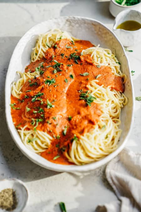 Big serving dish of spaghetti with Vegan Pasta Sauce on top.