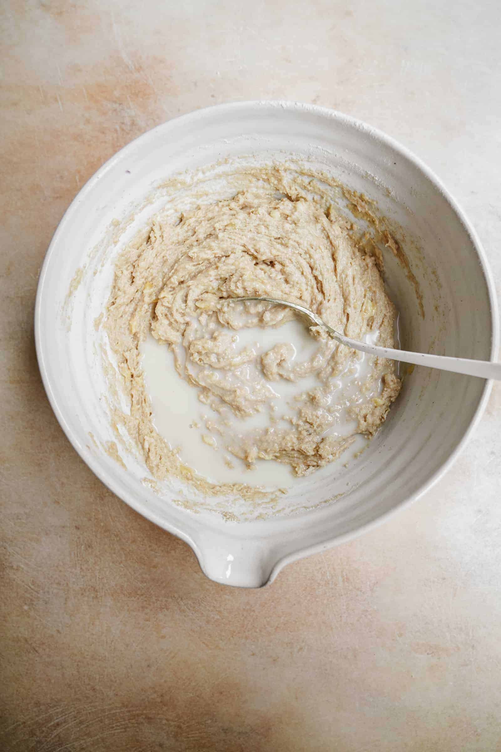 Ingredients mixed in a mixing bowl for vegan banana muffins