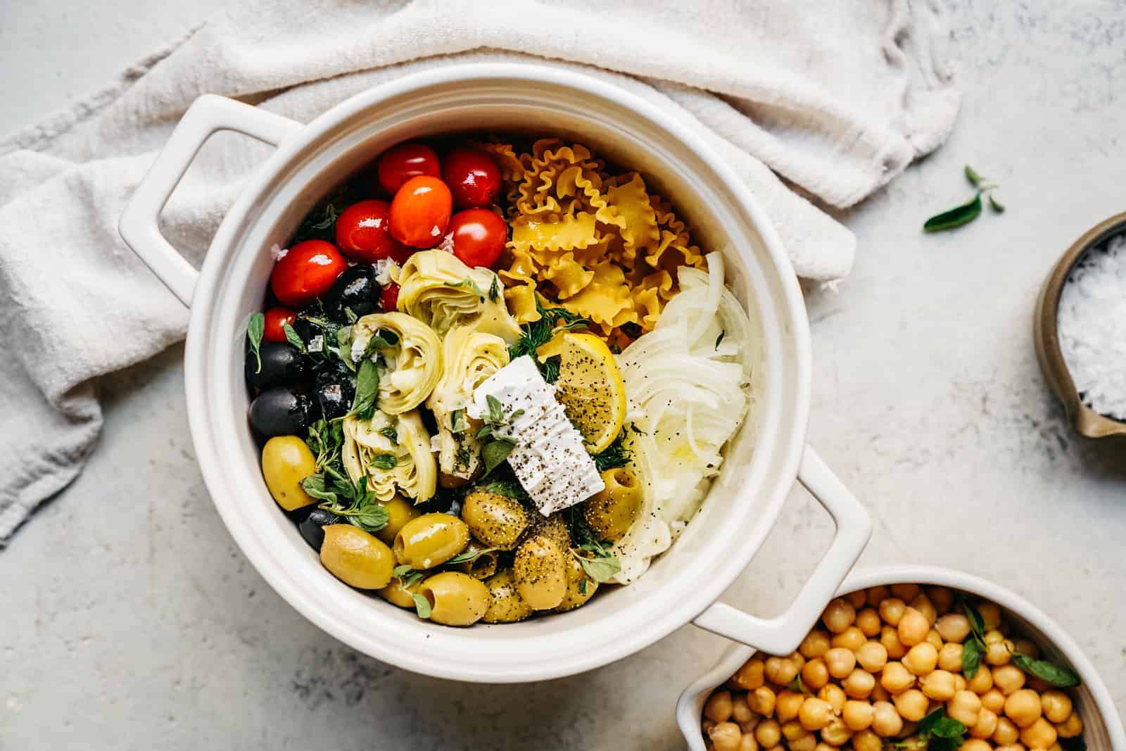 One-pot Greek pasta recipe in a large white serving bowl on counter