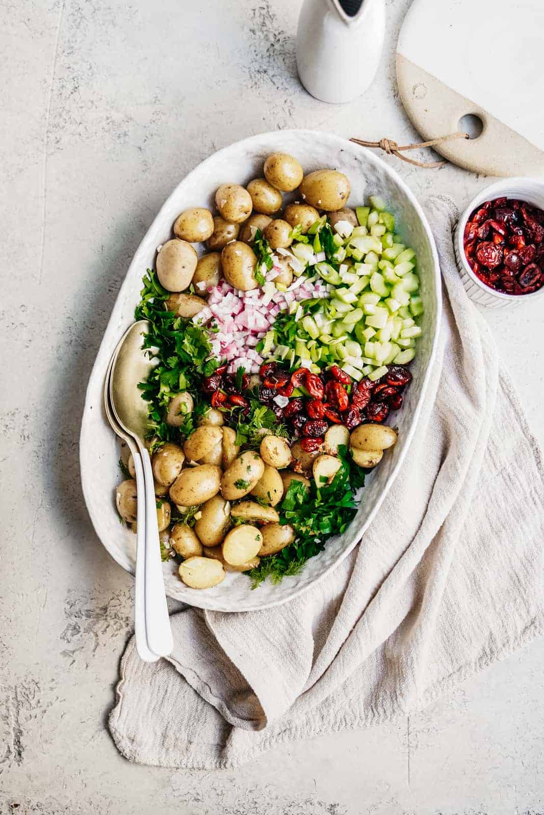 Vegan Potato Salad Recipe sitting on countertop in a serving dish ready to be served.