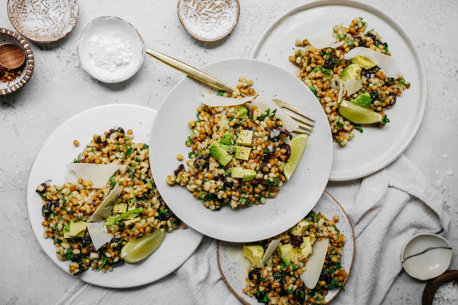 Multiple plates on table loaded with Simple Vegan Salad Recipe.