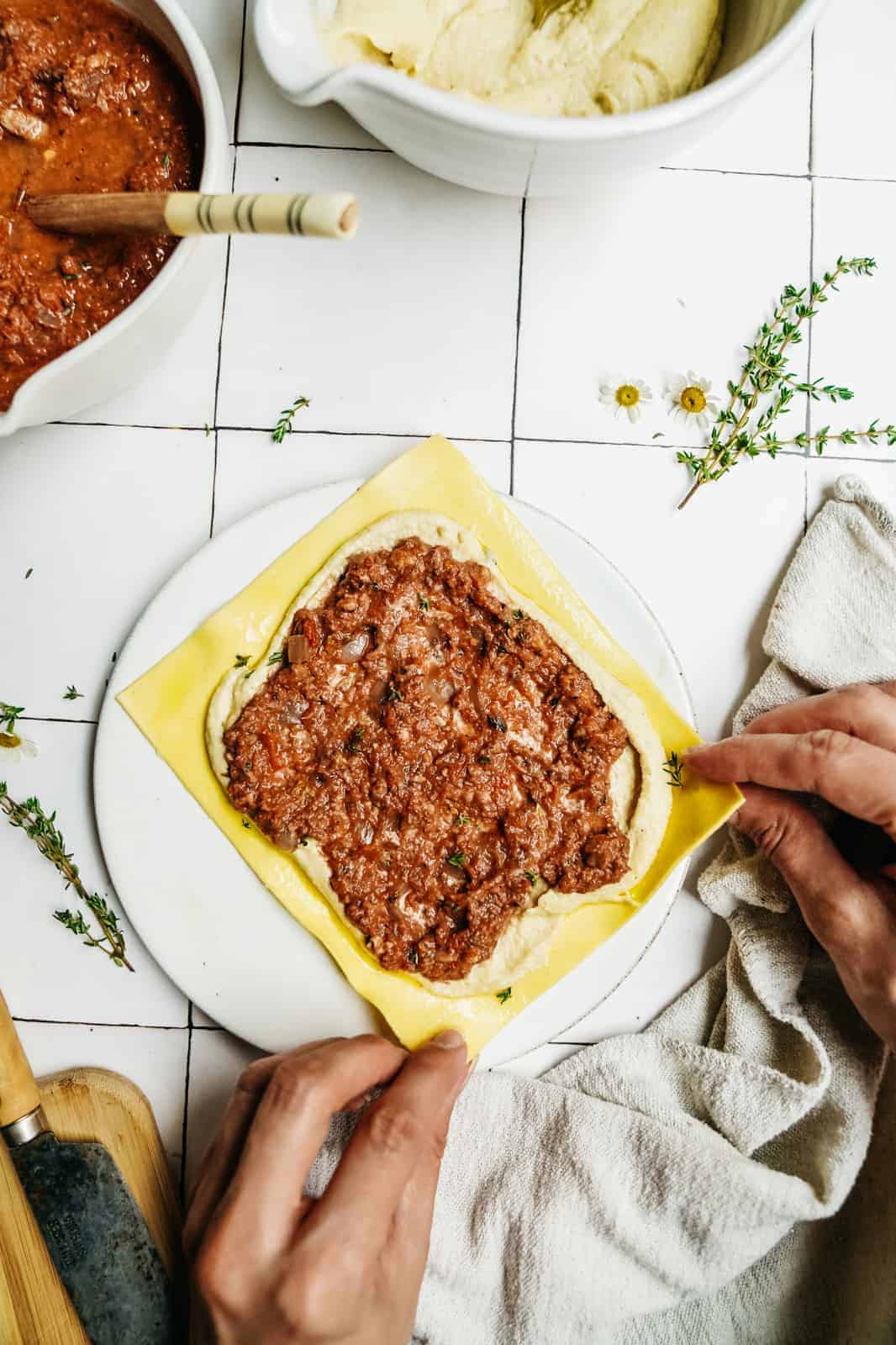 Rolling a lasagna roll to showcase the importance of adding movement into food photography.