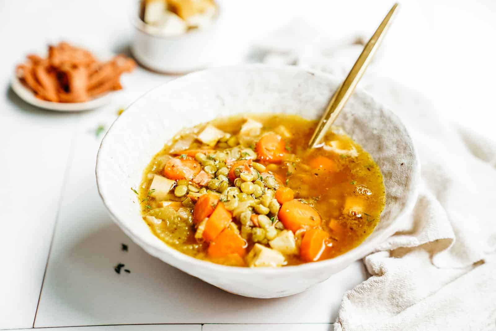 Vegan Split Pea Soup sitting on counter in big white bowl.