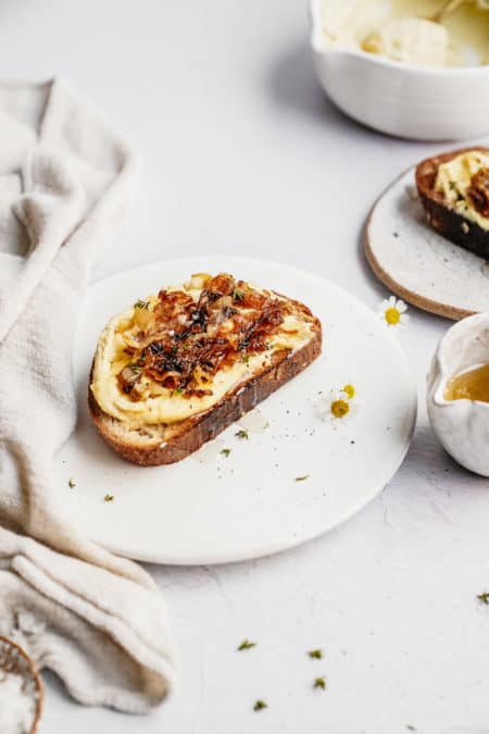 Plate with toast on it with cashew ricotta on top