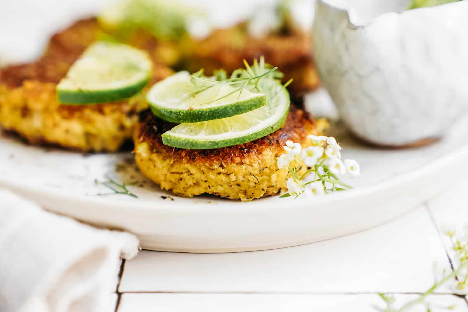Plate of Vegan Crab Cakes and Dilly Tartar Sauce on a white plate ready to be served.