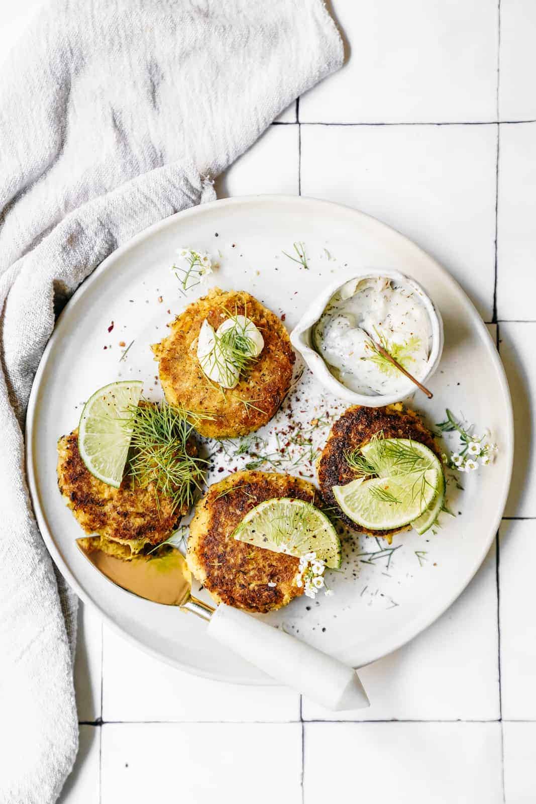 Plate of Vegan Crab Cakes and Dilly Tartar Sauce on a white plate ready to be served.