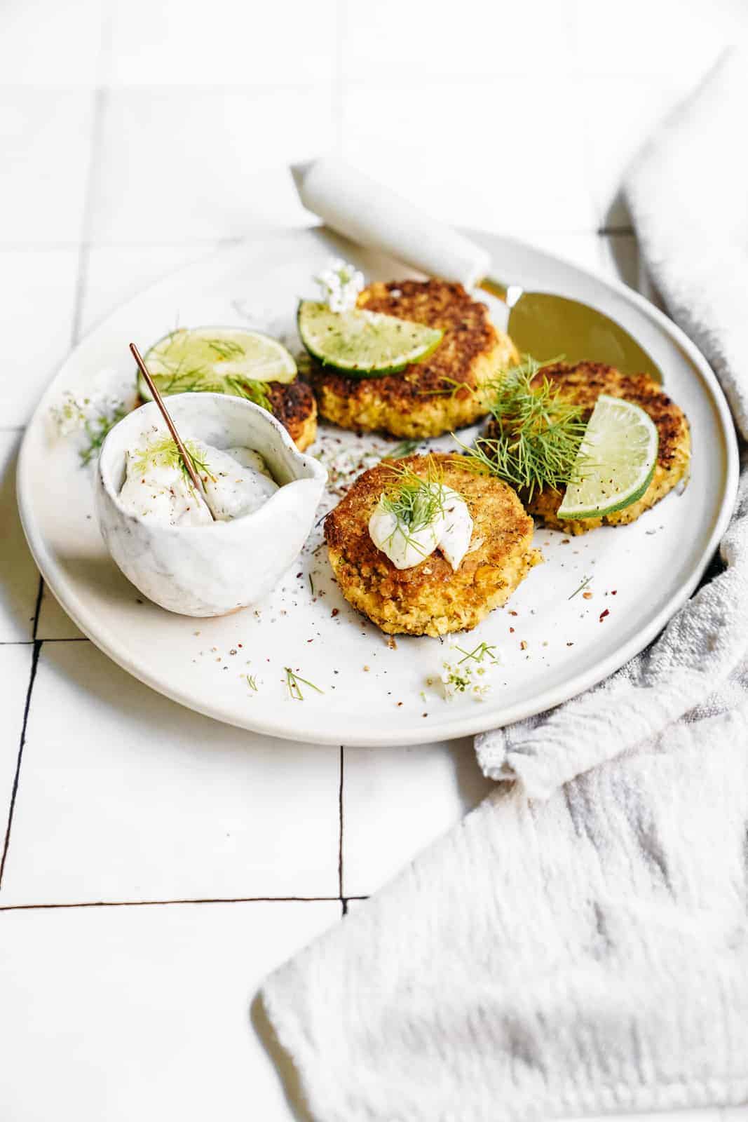 Plate of Vegan Crab Cakes and Dilly Tartar Sauce on a white plate ready to be served.