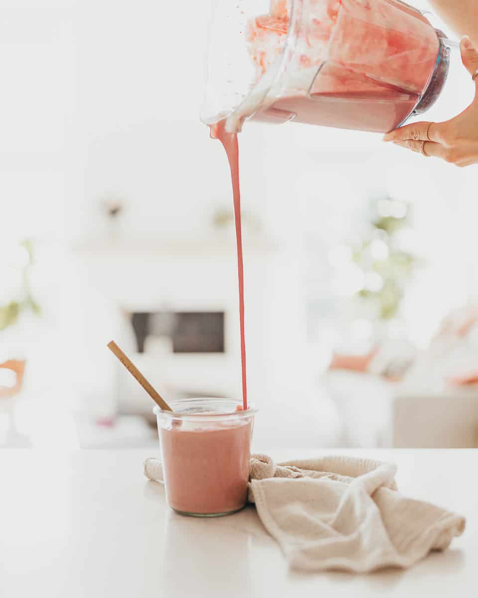 Vegan Protein Smoothie being poured from blender into a cup
