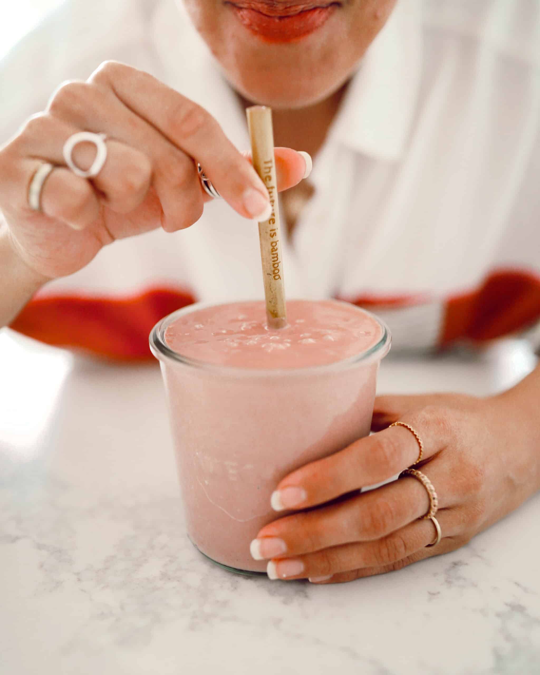 Maria taking a sip of her Vegan Peaches and Cream Smoothie.