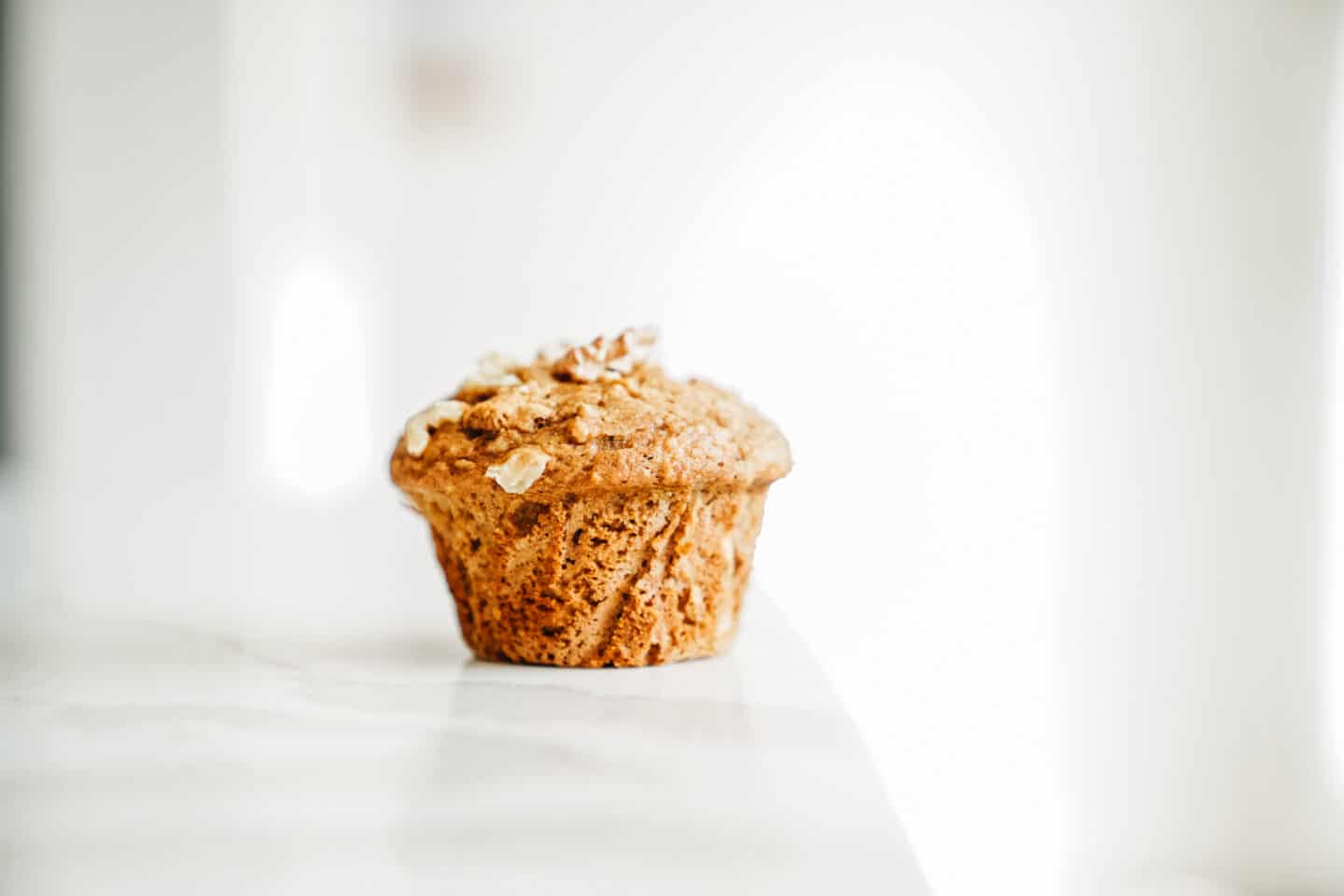 A single Apple Cinnamon Muffin on counter. An easy recipe to make this September.