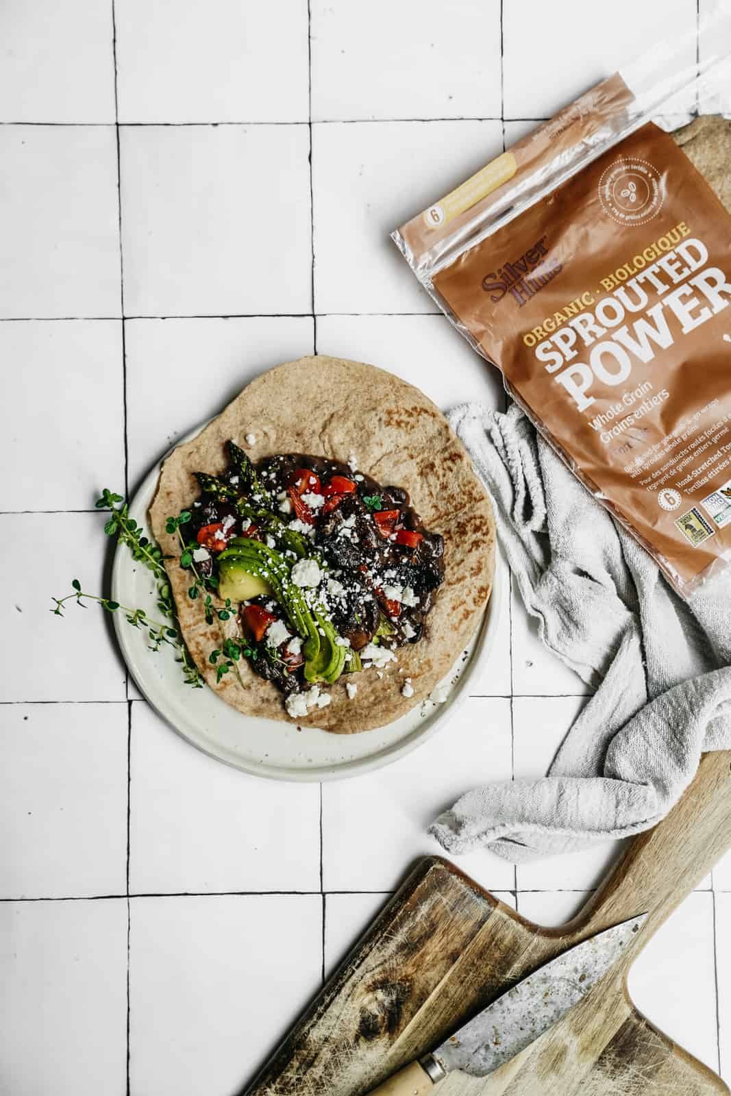 Grilled Vegetable Wrap laying on countertop with package of tortillas.